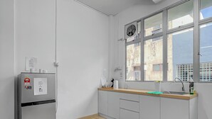 A modern kitchen with a built-in refrigerator, a window with a view of the city, and a wooden floor. - 3 Bedroom  (Batu Pahat)