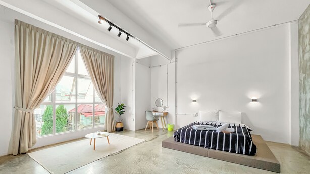 A modern bedroom with a bed, a desk, a chair, and a large window with curtains. - 3 Bedroom  (Batu Pahat)