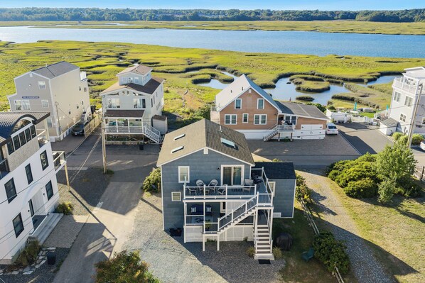 A coastal property with multiple buildings, a parking area, and a view of a lake. - Blue Tides (Wells)