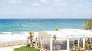 A beachside restaurant with a view of the ocean. - Dione Seaside Apartment with Sea View (Anissaras)