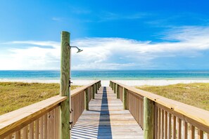 A wooden boardwalk leading to a beach with a clear view of the ocean. - Gulf Front | Private Pool | Elevator | Boardwalk (Gulf Shores)