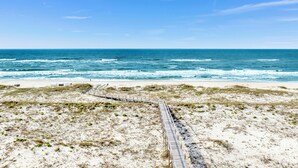 A beach with a wooden boardwalk leading to the shore, sandy dunes, and the ocean. - Kiva Dunes Luxury Retreat | Private Pool | Gulf Views (Gulf Shores)