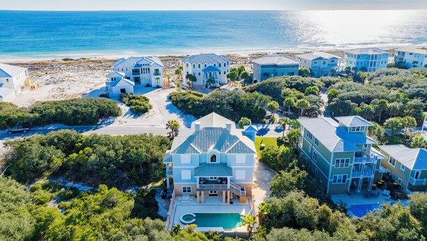 A coastal residential area with multiple houses, a swimming pool, and a beach in the background. - Kiva Dunes Luxury Retreat | Private Pool | Gulf Views (Gulf Shores)