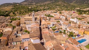 A densely packed town with historic buildings, narrow streets, and a prominent church tower.