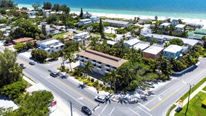 A coastal residential area with houses, a road, and a beach.