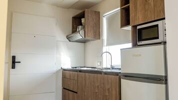 Deluxe Studio, Balcony | Private kitchen | Full-sized fridge, microwave, stovetop, cookware/dishes/utensils