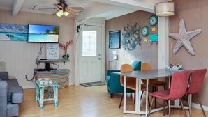 Un espace repas comprenant une table, des chaises et un ventilateur de plafond.