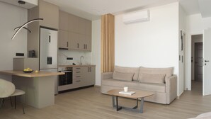 A modern kitchen with a built-in island, a sofa, and a coffee table.