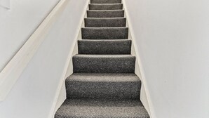 A staircase with carpeted steps leading upwards. - 20% off! Boutique Doncaster Abode - Sleeps 6! (Doncaster)