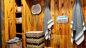 A wooden cabin interior with a sign saying "Always something to be thankful for," a sign instructing to move ski boots, a woven basket, and a bench. - NEW LISTING! Ski, Play, Stay @ The Lodge is loaded! Hot tub, BBQ, sleeps 10,  (Naches)