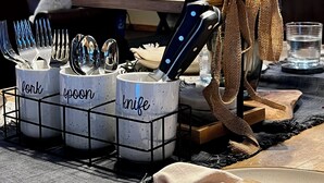 A dining area with a knife rack, utensil holders labeled 'fork', 'spoon', and 'knife', a vase with red berries, and a wooden table. - NEW LISTING! Ski, Play, Stay @ The Lodge is loaded! Hot tub, BBQ, sleeps 10,  (Naches)