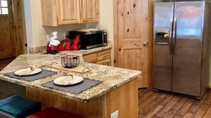 A kitchen with wooden cabinets, a stainless steel refrigerator, a microwave, and a granite countertop. - NEW LISTING! Ski, Play, Stay @ The Lodge is loaded! Hot tub, BBQ, sleeps 10,  (Naches)
