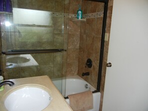 A bathroom with a glass-enclosed shower, a bathtub, and a sink. - Moose Traks
Come stay in Downtown Red Lodge, 2 blocks from Broadway Street (Red Lodge)