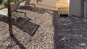 Un patio con mobiliario exterior, una pérgola y vistas del paisaje circundante.
