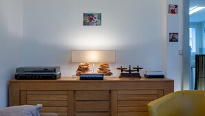 A room with a wooden cabinet, a lamp, and a record player.