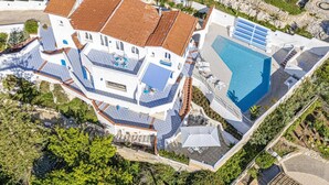 A large, multi-story building with a swimming pool and outdoor seating areas. - Villa Blu Marino by Villa Plus (Syracuse)
