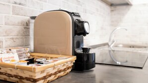 A kitchen with a coffee machine, a basket of pastries, and a water dispenser. - Trevi Ducal Palace I (Roma)