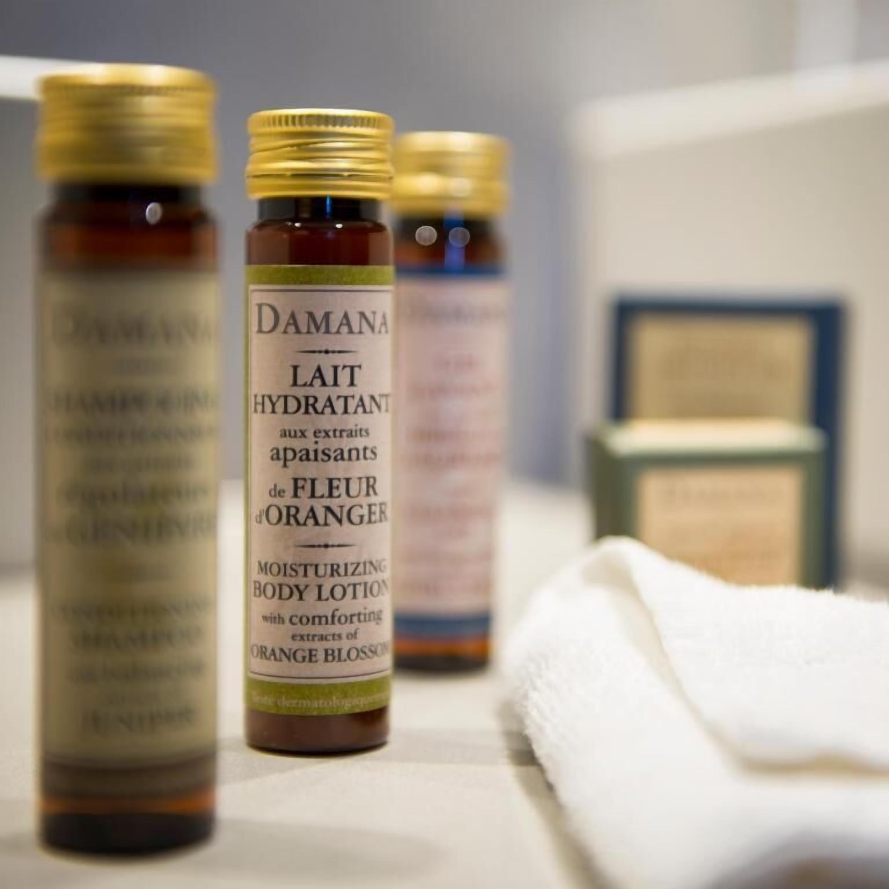Bottles of Damana Lait Hydratant body lotion with orange blossom extracts.