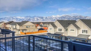 A residential area with houses and a mountain range in the background. - NEW Mountain Views | Hot Springs | Truck Stop (Bozeman)
