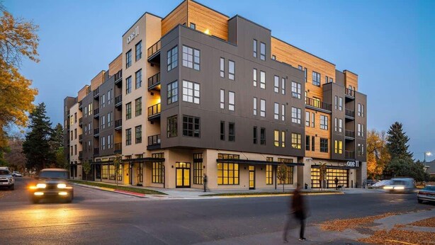 A multi-story hotel with a modern design, featuring balconies and large windows. - Cozy Downtown Condo (Bozeman)