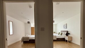 A bedroom with a bed, bedside table, and a nightstand.
