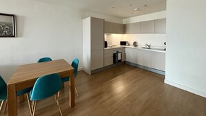 A modern kitchen with a dining area.