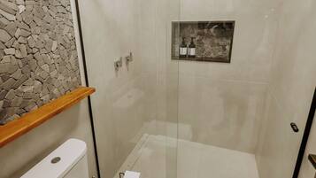 Une salle de bain moderne avec une douche à parois de verre, des toilettes et un mur en pierre.