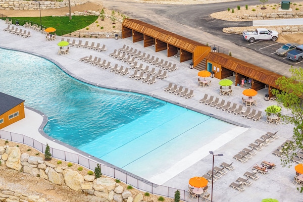 Resort-style pool with cabanas and loungers. Zero entry!