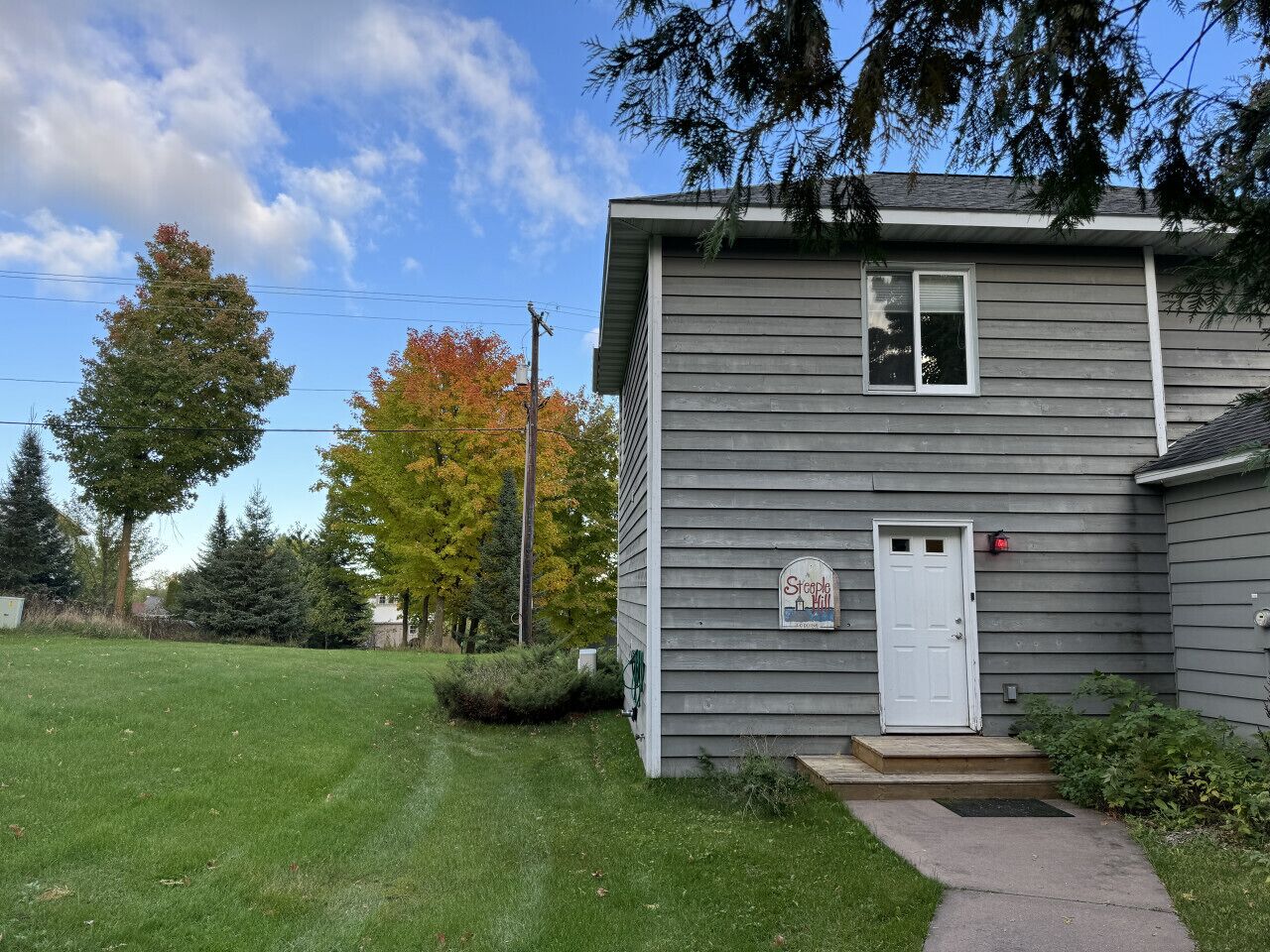 A single-story building with a white door and a small porch.