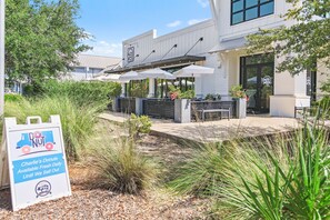A building with outdoor seating and a sign for 'Charlie's Donuts'. - VitaSea/Private Beach/Bike2Seaside (Santa Rosa Beach)