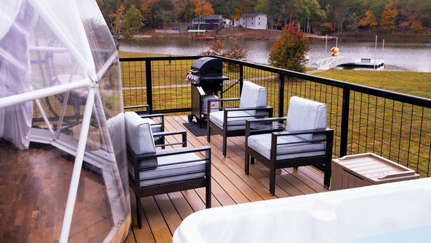A deck with outdoor furniture, a hot tub, and a grill. - Lake Front Geodesic Dome: Hot Tub & Lake Views (Cedar Bluff)