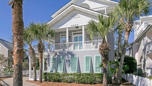 A beachfront property with a balcony, palm trees, and a white fence. - Private Pool 🏊 Walk to Beach 🏖️ Family Tides 🏝️ (Destin)