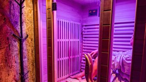 A sauna with wooden slats and a digital display.