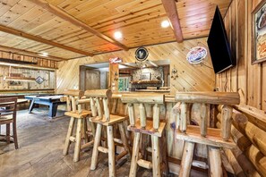 A wooden bar area with stools, a pool table, and a billiards table. - Big Woods and Yellow River (Necedah)