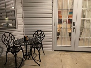 Enjoy a peaceful evening on the patio with a round table and two chairs.