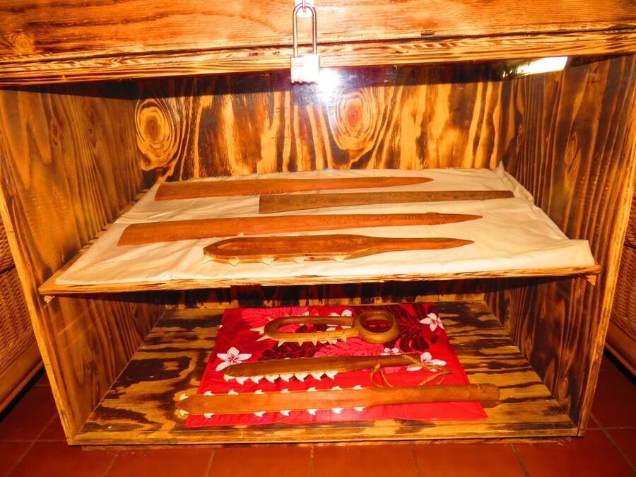 A wooden cabinet with a hinged lid, a flat surface, and a patterned cloth.
