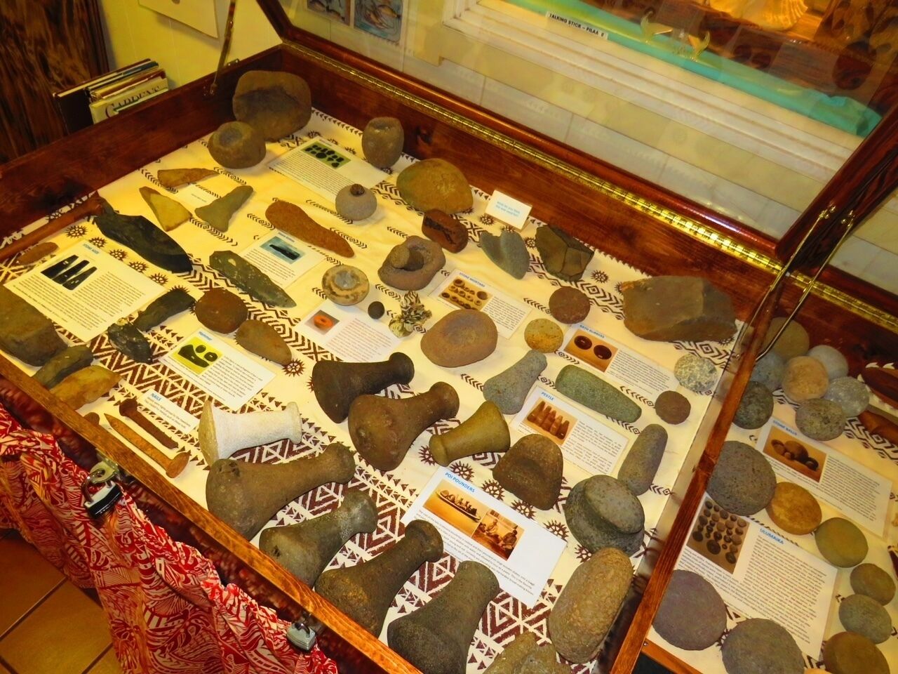 A display of various rocks with informational placards in a museum setting.