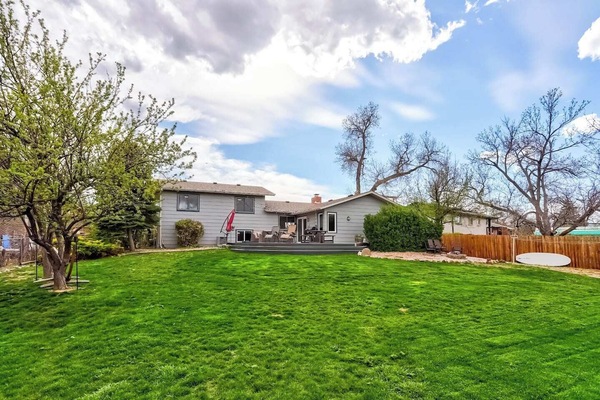 Enjoy a large, fully fenced backyard with a huge deck perfect for grilling or cozy nights by the firepit. Plus, with a doggy door for easy access, your pups can come and go as they please, making this the ideal retreat for everyone in the family!