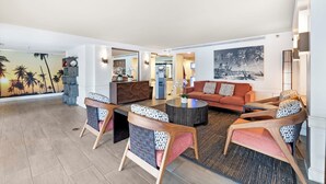 A spacious living area with a sofa set, a coffee table, and a decorative wall mural. - NEW! Stylish and Cozy Studio near Waikiki Beach! (Honolulu)