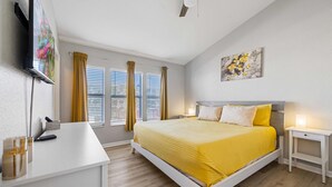 A bedroom with a bed, bedside tables, a desk, and a TV. - Gorgeous Vacation Home With Pool Close To Disney (Kissimmee)