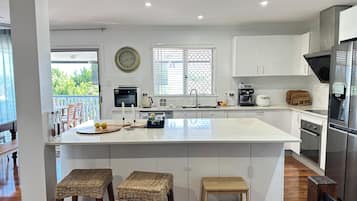 Fridge, microwave, coffee/tea maker, cookware/dishes/utensils