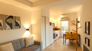 A modern apartment with a living room, kitchen, and dining area.