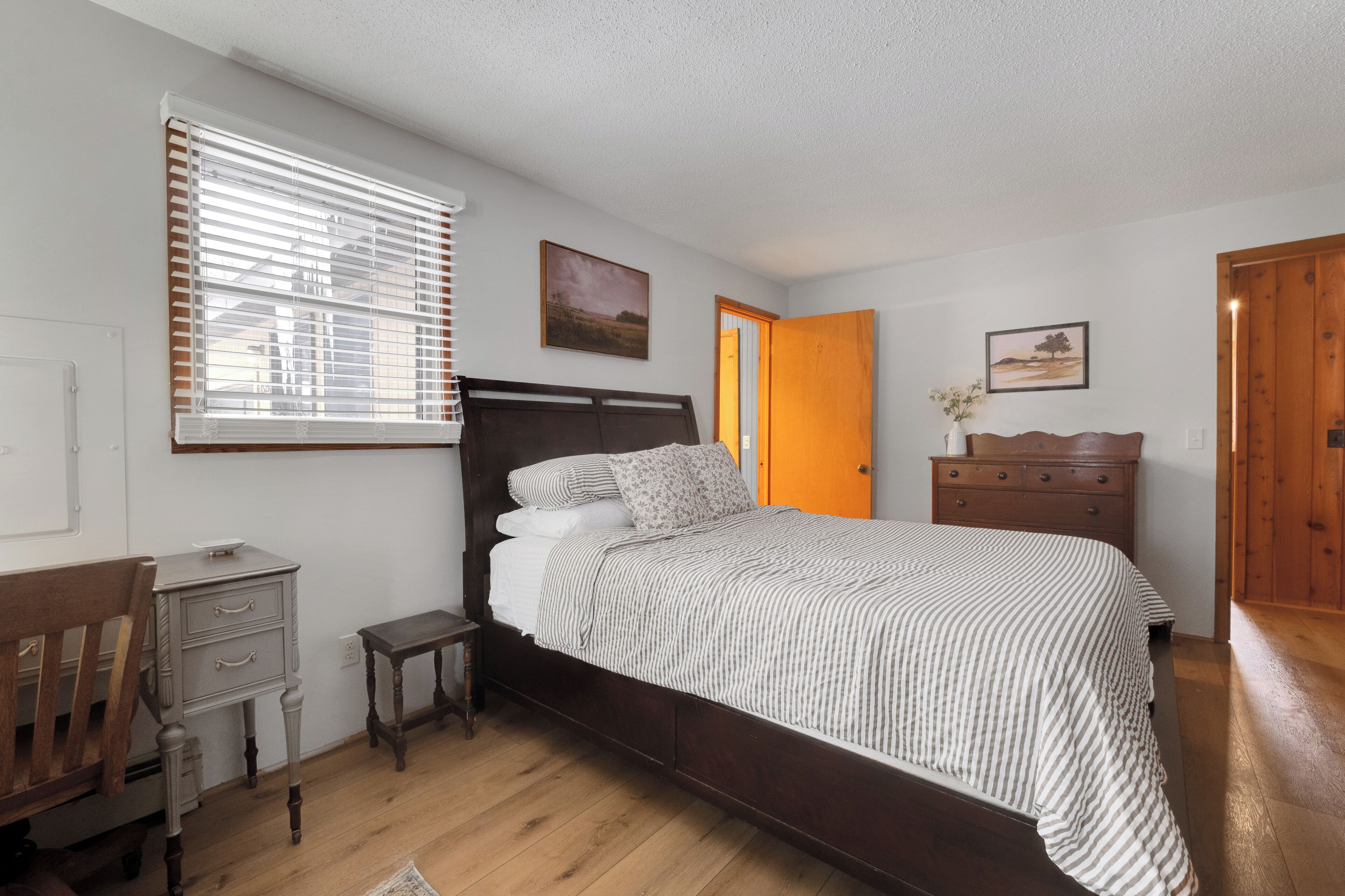The main bedroom features a queen bed, dual closets, and a dedicated workspace, offering the perfect balance of relaxation and productivity.