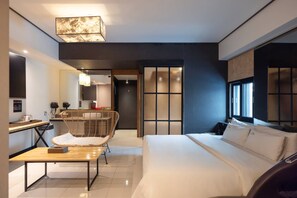 A modern hotel room with a bed, a desk, a chair, and a large window. - From H Maru Hotel Pocheon (Pocheon)