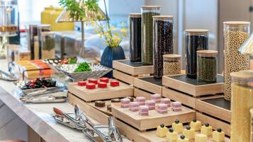 A buffet setup with various food items and containers.