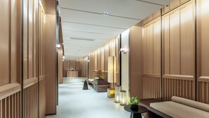 A hallway with wooden paneling, a bench, and a small table with a plant. - Holiday Inn Express Haikou World Trade Center by IHG (Haikou)