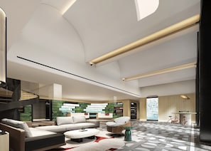 A modern interior with a curved staircase, a sectional sofa, a round coffee table, and a patterned floor. - EVEN Hotel Quanzhou City Center by IHG (Quanzhou)