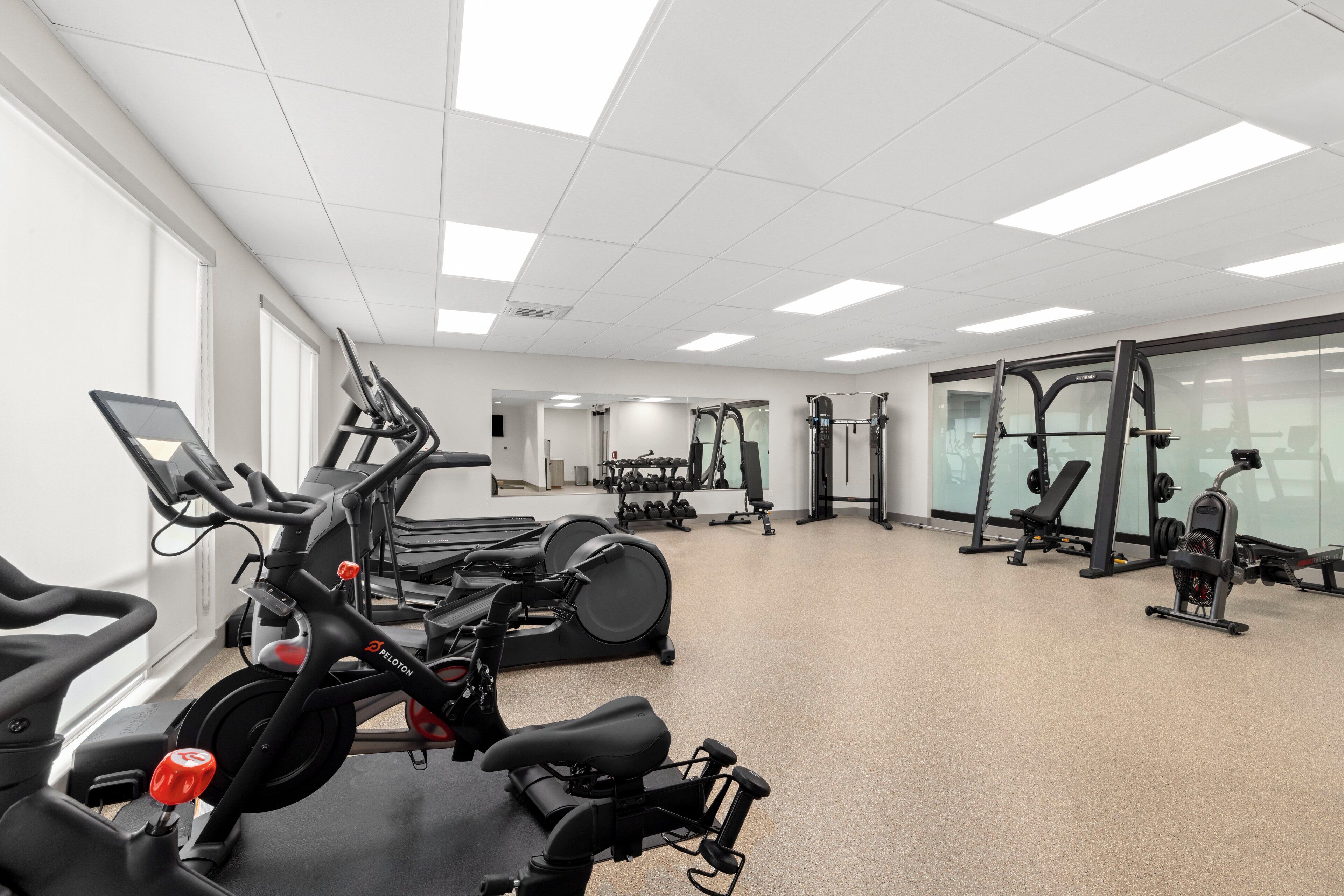 A gym with stationary bikes, treadmills, and weight machines.