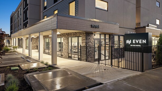 A modern hotel entrance with a stone facade, numbered 11784, and a gated driveway. - EVEN Hotel Portland – Beaverton by IHG (Portland)