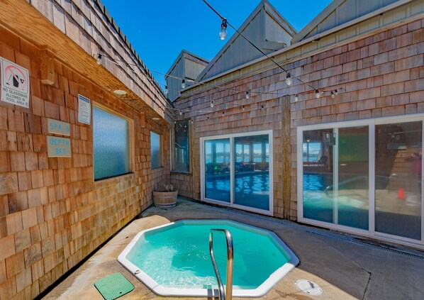 A wooden spa area with a 3ft deep pool, glass doors, and a sign prohibiting glassware.